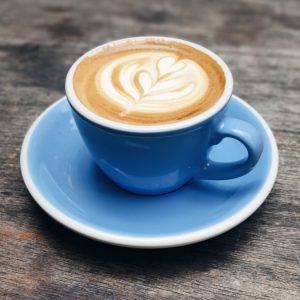 blue ceramic teacup with latte