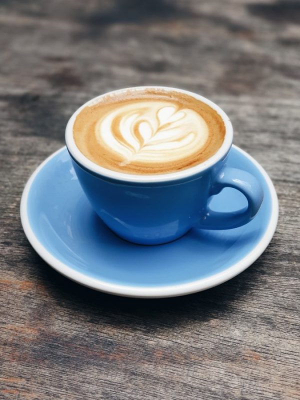 blue ceramic teacup with latte