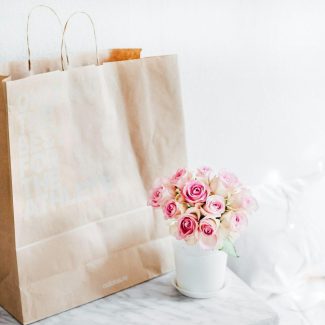 pink rose bouquet beside brown paper bag {{brizy_dc_image_alt imageSrc=